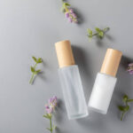 top view skincare bottles surface with lavender flower