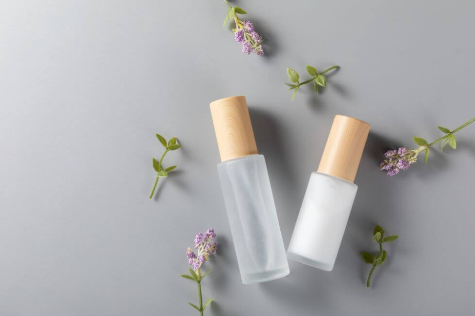 top view skincare bottles surface with lavender flower