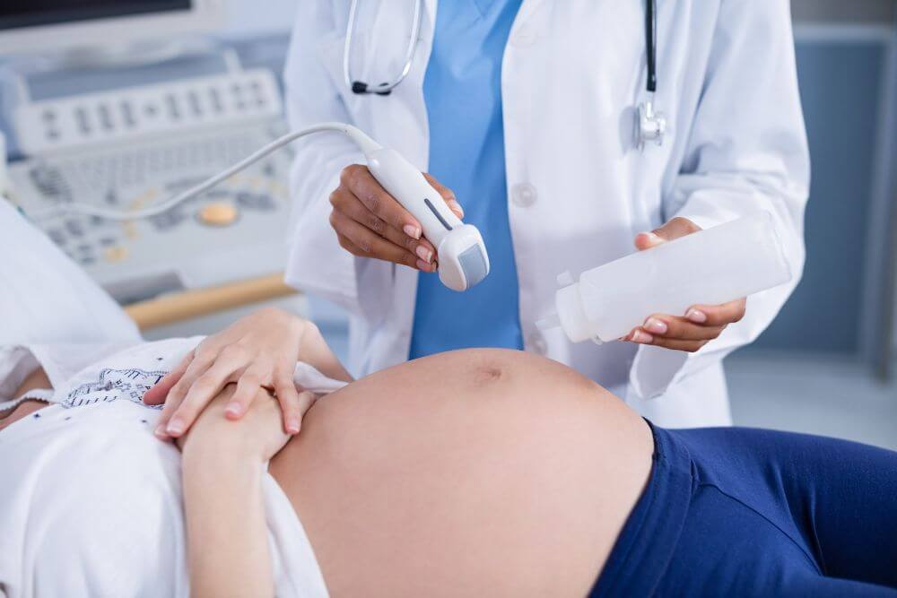pregnant woman receiving ultrasound scan stomach