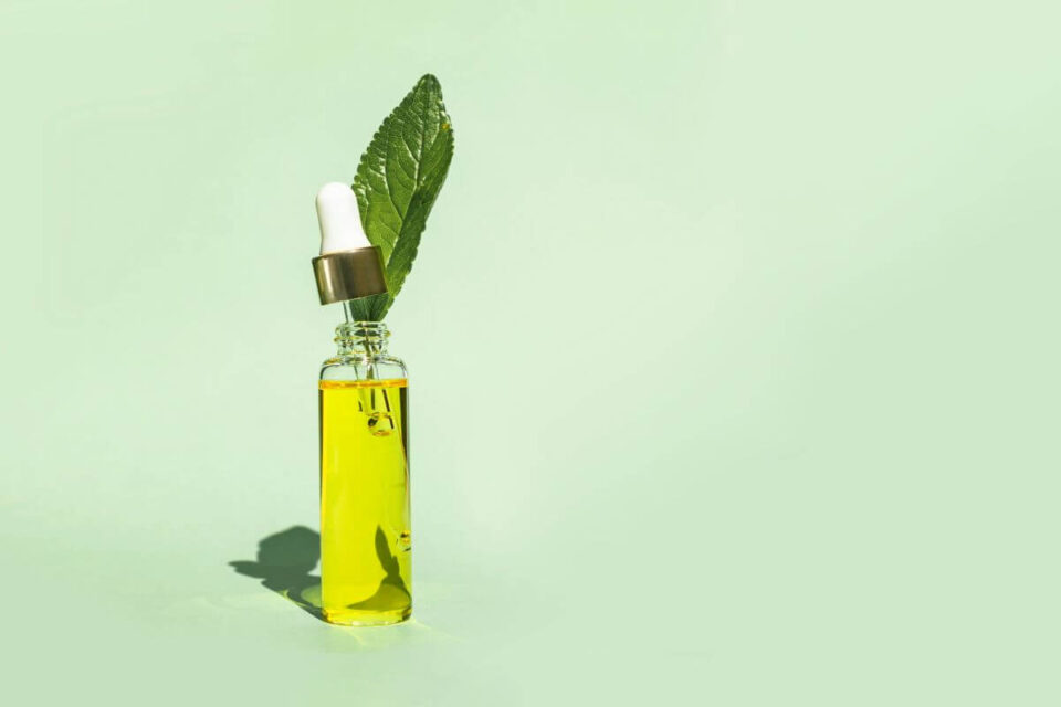 olejek z drzewa herbacianego na paznokcie buteleczka olejku z liśćmi
