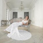 44362068 beautiful bride posing in wedding dress in a white photo studio