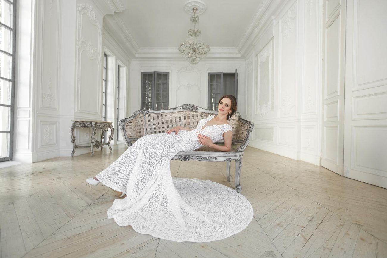 44362068 beautiful bride posing in wedding dress in a white photo studio