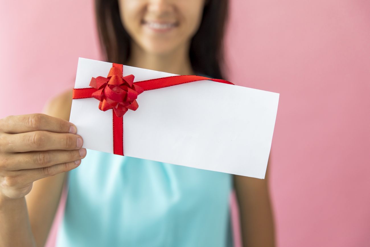 smiley woman showing envelope